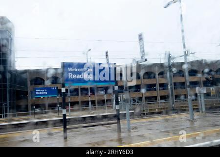 Welcome to the city of Reading sign blurred by rain on a British Rail empty train station platform wet summer day 2023 England Britain KATHY DEWITT Stock Photo