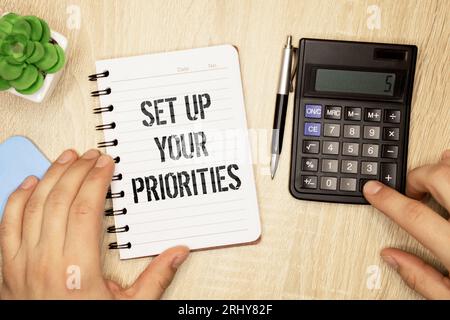 Set up your priorities sign on notepad on the white backgound. Stock Photo