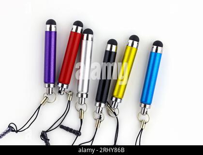 set of mini stylus for capacitive screens on a white background. Gray, red, blue and black stylus top view. Mini touch screen pen for tablet and smart Stock Photo