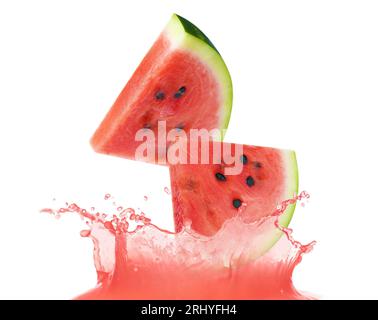 Cut watermelon falling into juice on white background Stock Photo