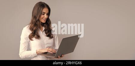 E-learning even from far away. Happy girl student use laptop. E-learning. Distance education. Woman isolated face portrait, banner with copy space. Stock Photo
