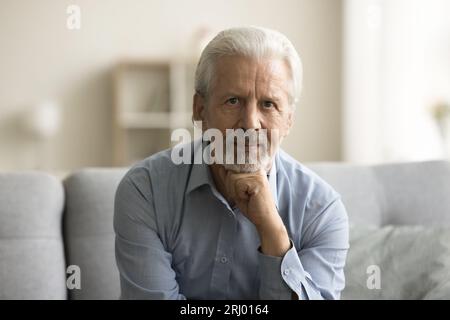 Serious confident senior retired man looking at camera Stock Photo