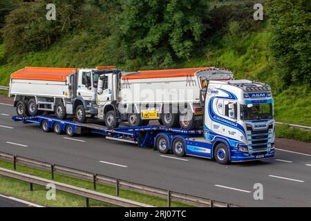 Heidelberg Materials Cement German Multinational DAF trucks being transported by A & M Commercials Ltd Scania Super 580S, Tractor units Trucks,Trailers and Plant Machinery; travelling on the M6 motorway in Greater Manchester, UK Stock Photo