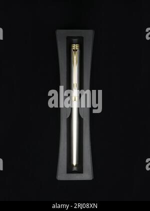 top view of a limited edition silver color business pen made of stainless steel isolated in a black background Stock Photo