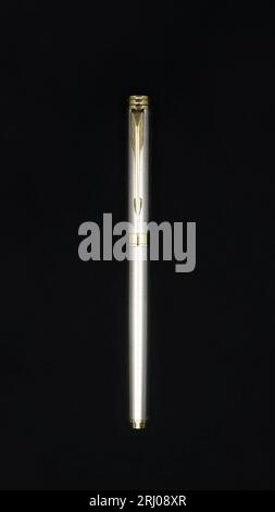 top view of a limited edition silver color business pen made of stainless steel isolated in a black background Stock Photo