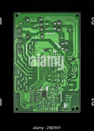 a green electronic printed circuit board (pcb) with communication processor of a controller manufactured with complex design and code for information Stock Photo