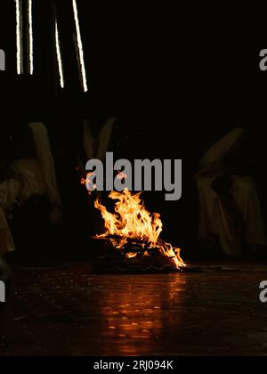 flames of fire burning and glowing at night in a religious camp Stock Photo