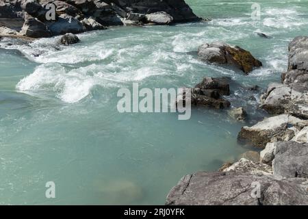 Fast water flowing between coastal rocks. Katun river. Altai Republic, Russia Stock Photo