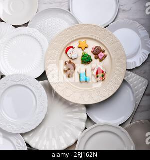 Many Different Delicious Christmas Cookies on White Plate, Flat Lay Stock Photo