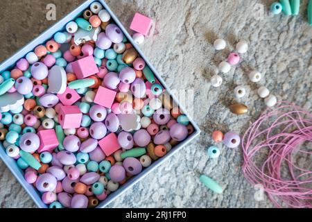 Wooden Beads on a String making a Colorful Toy Necklace Stock Photo - Alamy