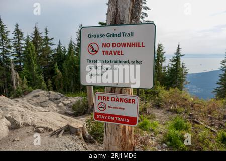 View of a warning sign along the Grouse Grind Trail in Vancouver indicating that downhill travel is prohibited Stock Photo