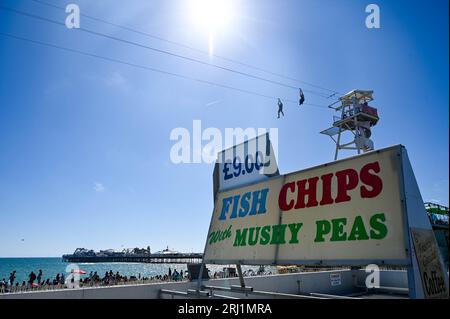 Brighton UK 20th August 2023 - Crowds enjoy the hot sunny weather on Brighton beach  and seafront as the South Coast enjoys the first nice weekend for a while  : Credit Simon Dack / Alamy Live News Stock Photo