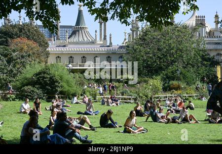 Brighton UK 20th August 2023 - Crowds enjoy the hot sunny weather in Brighton's Royal Pavilion Gardens as the South Coast enjoys the first nice weekend for a while  : Credit Simon Dack / Alamy Live News Stock Photo