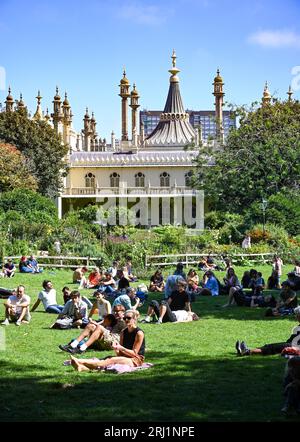 Brighton UK 20th August 2023 - Crowds enjoy the hot sunny weather in Brighton's Royal Pavilion Gardens as the South Coast enjoys the first nice weekend for a while  : Credit Simon Dack / Alamy Live News Stock Photo