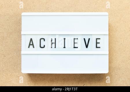 Lightbox with word achieve on wood background Stock Photo