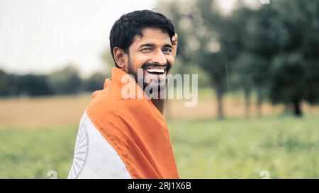 Cheerful indian holding indian national flag, happy independence day, 15th of august, republic day, Protestantism concept. Stock Photo