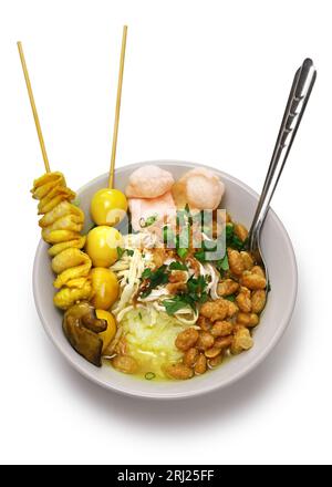 Bubur ayam, an Indonesian porridge dish. breakfast staple isolated on white background. Stock Photo