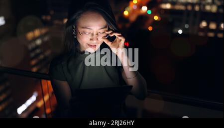 Glasses, tablet and Asian woman in night office, working late on project deadline or research. Tech, overtime and female employee with touchscreen Stock Photo