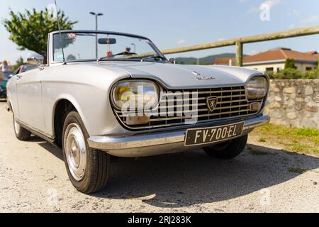Langeac, France - May 27, 2023: Peugeot 204 cabriolet in silver, on display in the city. Stock Photo