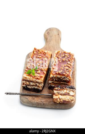Layered  cake with caramel cream and nuts isolated on white Stock Photo