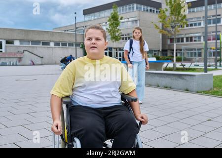 Children go to school, disabled boy 11, 12 years old on a wheelchair close-up Stock Photo