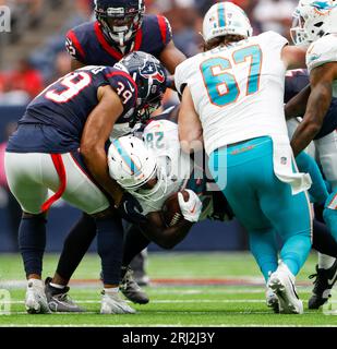 August 19, 2023: Houston Texans safety Eric Murray (23) tackles Miami  Dolphins running back De'Von Achane (28) during an NFL preseason game  between the Texans and the Dolphins Jaguars on August 19