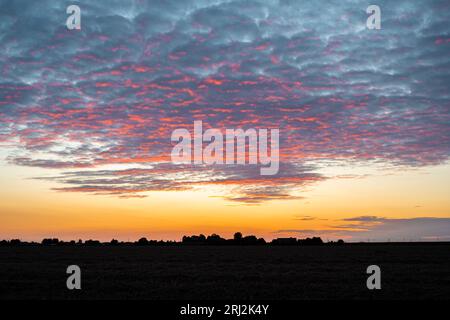 Purple colored altocumulus clouds at sunset Stock Photo