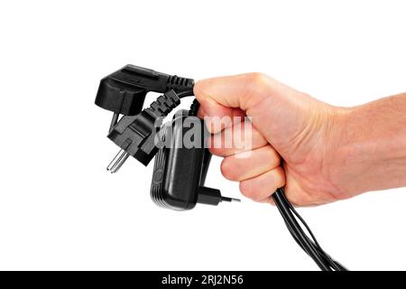 Bundle of disconnected black plugs with cables in hand isolated on white background Stock Photo