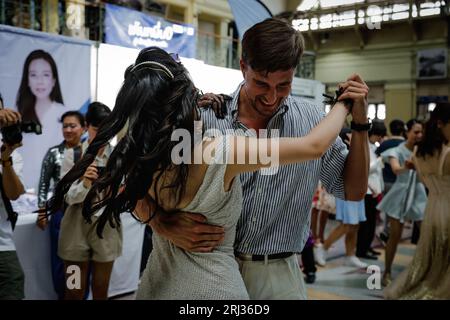 Bangkok, Thailand. 19th Aug, 2023. People swing dancing during a vintage-themed swing dance party at Hua Lamphong railway station in Bangkok. Hundreds of Thai and foreign dance enthusiasts dressed in retro fashion style costumes and turned the passenger hall of Bangkok's century old railway station to a dancing floor of a 1930s-inspired swing dance party with swing jazz music aimed to promote the social dances. The swing dancing party is held by Bangkok Swing, a community of local and foreign swing dancers. (Credit Image: © Wissarut Weerasopon/ZUMA Press Wire) EDITORIAL USAGE ONLY! Not for Co Stock Photo