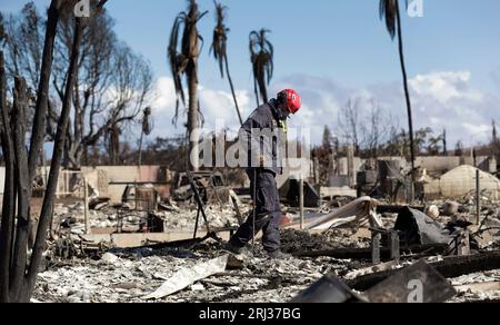 A member of the Federal Emergency Management Agency’s Urban Search and Rescue Team combs through a neighborhood destroyed by a wildfire in Lahaina, Hawaii, August 17, 2023. CBP photo by Glenn Fawcett Stock Photo