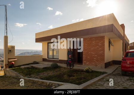 La Paz, La Paz, Bolivia – August 15, 2022: Young Family Smile on the Porch on their New Modern House in Lomas de Achumani Neighborhood Stock Photo