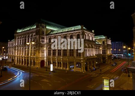 An aerial view of an intersection in front of Vienna's State Opera House, featuring numerous illuminated street lights Stock Photo