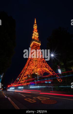 a closeup of beautiful Tokyo Tower with cars passing by at night Stock Photo