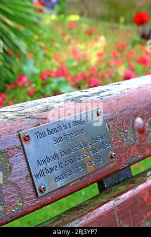 This bench is a designated Sun Free Zone - Anyone found reading The Sun, will have it confiscated and will be escorted from the city of Liverpool Stock Photo