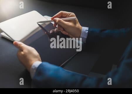 Business man, graphic designer using stylus pen on digital tablet screen, Man in casual ware online working Stock Photo