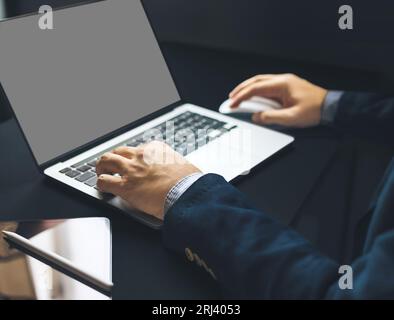 Business man hand typing on laptop computer on office table, close up Stock Photo