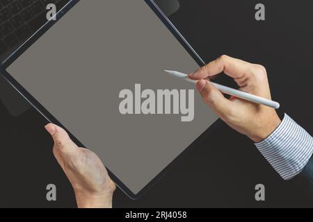 Business man, graphic designer using stylus pen on digital tablet screen, Man in casual ware online working Stock Photo