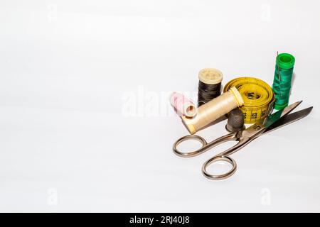 A close-up view of assorted sewing materials artfully arranged on a  white surface Stock Photo