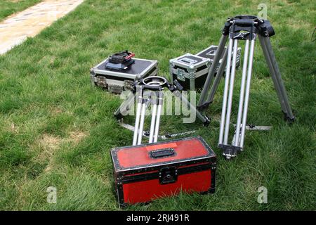 Photography three tripod and tin box on the lawn in a park Stock Photo