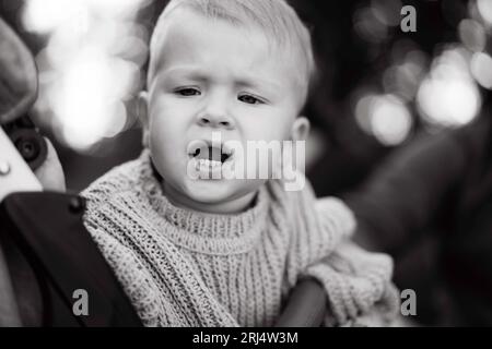 cute caucasian baby boy sitting in a buggy scared or upset Stock Photo