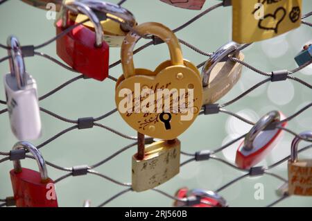 Love padlock attached to metal mesh on a bridge in Salzburg, Austria. Stock Photo