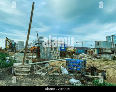 construction debris lies near houses under construction from concrete blocks. construction of a new residential area in the city center. construction Stock Photo