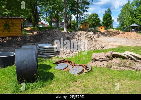 Large round concrete cement stone rings for the construction of sewage wells during the construction of the house. Stock Photo