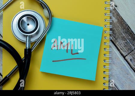 Concept of AML write on sticky notes with stethoscope isolated on Wooden Table. Stock Photo