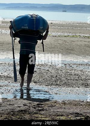 Man carrying inflatable kayak Stock Photo