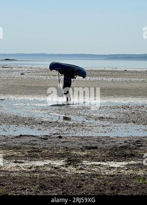 Man carrying inflatable kayak Stock Photo