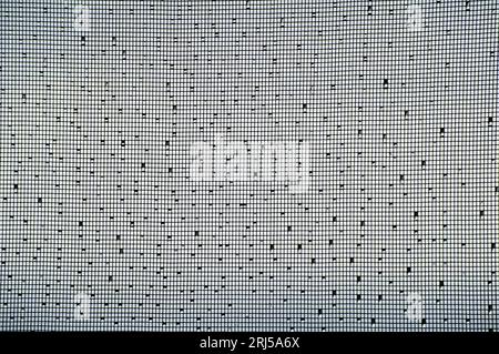 Steel mesh fly screen after rain. Water droplets randomly scattered on rectangular shaped black wire mesh. Pattern, background,abstract. Australia. Stock Photo