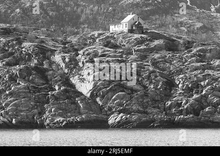 Black And White Photo Of The Norwegian Bjørnøy Lighthouse, Built In 1890, Located On The Small Island Of Bjørnøya, 16km North Of Bodø, Norway Stock Photo