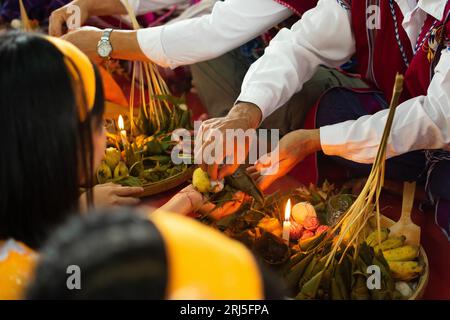 Karen traditional wrist tying ceremony: Tying white and red cotton threads on their wrist. One of the most famous event. Stock Photo