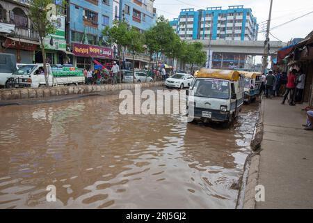 Human howlers on a submerged road at Jurain in Dhaka, Bangladesh. Stock Photo